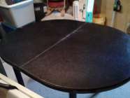 Black ,oval ,metal legs, very sturdy.
 No chairs 
Or ...