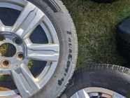 Four 225/65R17 tires on aluminum GMC rims - Photo 1 of 4