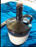 PRIMITIVE BROWN & WHITE STONEWARE LONG NECK WHISKY
